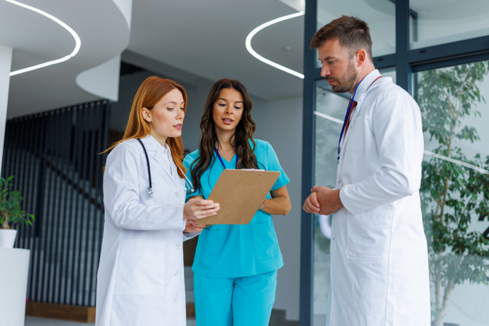 Medical team reviewing patient chart in hallway